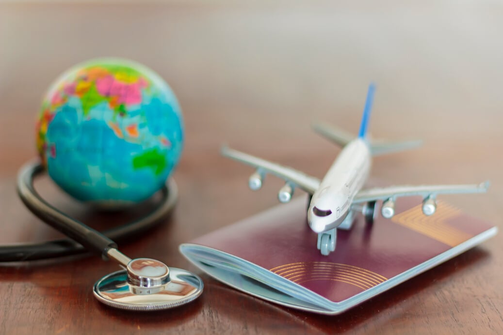 Stethoscope , passport document, airplane and globe. Healthcare and travel insurance concept